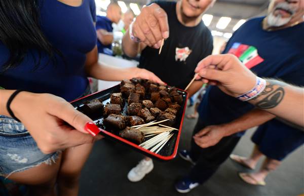 Care-carrying medical marijuana patients sample the brownies at Los Angeles' first-ever cannabis farmer's market at the West Coast Collective medical marijuana dispensary in July last year. FREDERIC J. BROWN / AFP via Getty Images File