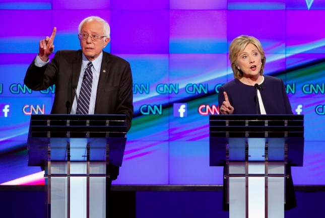 Hillary Rodham Clinton, right, and Sen. Bernie Sanders, of Vermont, speak during the CNN Democratic presidential debate Tuesday, Oct. 13, 2015, in Las Vegas. (AP Photo/John Locher)