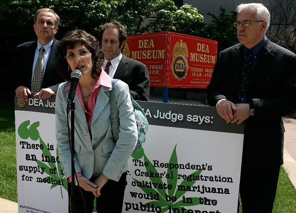 ARLINGTON, VA – MAY 23: Medical marijuana user Angel Raich (2nd L) of Oakland, California, speaks as (L-R) clinical neurologist Denis Petro, Rick Doblin, President of the Multidisciplinary Association for Psychedelic Studies, and Lyle Craker, professor of plant and soil science of University of Massachusetts, look on during a news conference in front of the headquarters of U.S. Drug Enforcement Administration to call on the administration to accept the recommendation from a DEA administrative law judge to end the federal monopoly on the supply of marijuana that can be used in FDA-approved research May 23, 2007 in Arlington, Virginia. Angel Raich, 41 suffers from an inoperable brain tumor as well as several other complex medical conditions and began using medical marijuana to ease pain and gain appetite after her doctor suggested it in 1997. Coming from a conservative upbringing, Angel didn’t feel comfortable using an illegal substance, especially in front of her children. Raich sued U.S. Attorney General John Ashcroft and Drug Enforcement Administration director Asa Hutchinson to block them from interfering with her medical marijuana use and to avoid drug charges and arrest. Angel lost her case and appeal. She is now preparing to undergo treatment for her brain tumor. (Photo by Alex Wong/Getty Images)