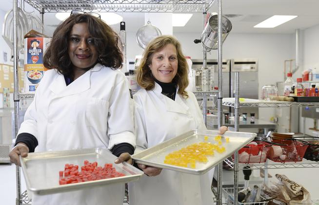 Owners Deloise Vaden, left, and Elyse Gordon show off marijuana edibles in the kitchen of their business, Better Baked, in Denver. (Cyrus McCrimmon, The Denver Post)