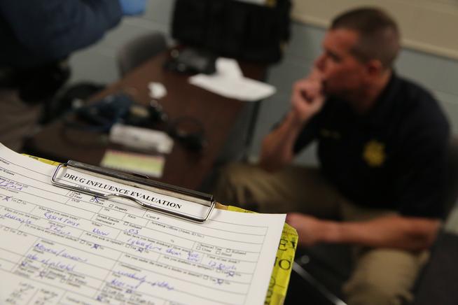 Sgt. David Blatner sits near a completed roadside Drug Influence Evaluation sheet on a clipboard, at the Colorado State Patrol Training Academy, in Golden, Colo., Thursday March 6, 2014. (Brennan Linsley, Associated Press file)