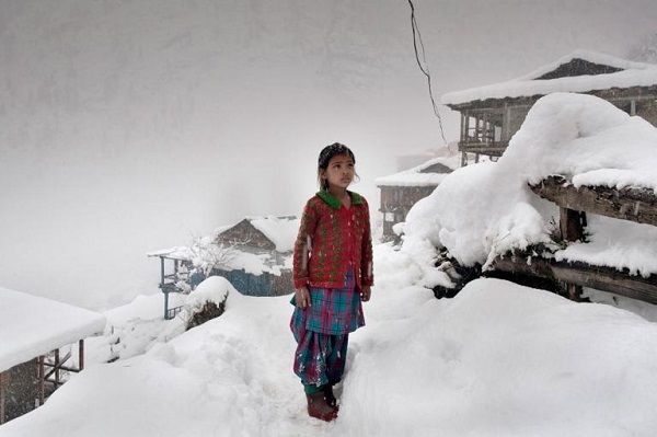 A local girl stares at the mountain peaks after a big snowfall caused her village to lose electricity. PHOTOGRAPH BY ANDREA DE FRANCISCIS