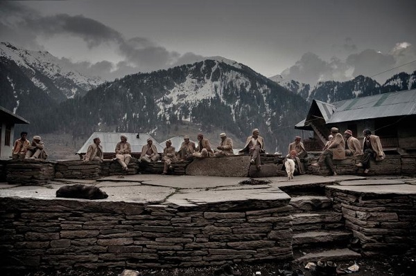 Elders sit in the village square near the temple. They were part of the first generation to cultivate and harvest the wild cannabis grown in the village today. PHOTOGRAPH BY ANDREA DE FRANCISCIS