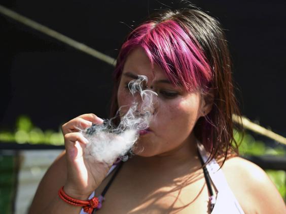 A woman smokes marijuana during a rally in front of the Supreme Court of Justice in Mexico City (AFP/Getty)