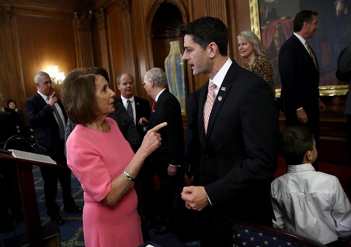 U.S. Speaker of the House Paul Ryan (R) (R-WI) speaks with House Minority Leader Rep. Nancy Pelosi (D-CA) following an event marking the passage of the 21st Century Cures Act at the U.S. Capitol December 8, 2016 in Washington, DC. The bill, passed with bipartisan support, provides funding for cancer research, the fight against the epidemic of opioid abuse, mental health treatment, and aids the Food and Drug Administration in expediting drug approvals, among other things. (Photo credit: Win McNamee/Getty Images)